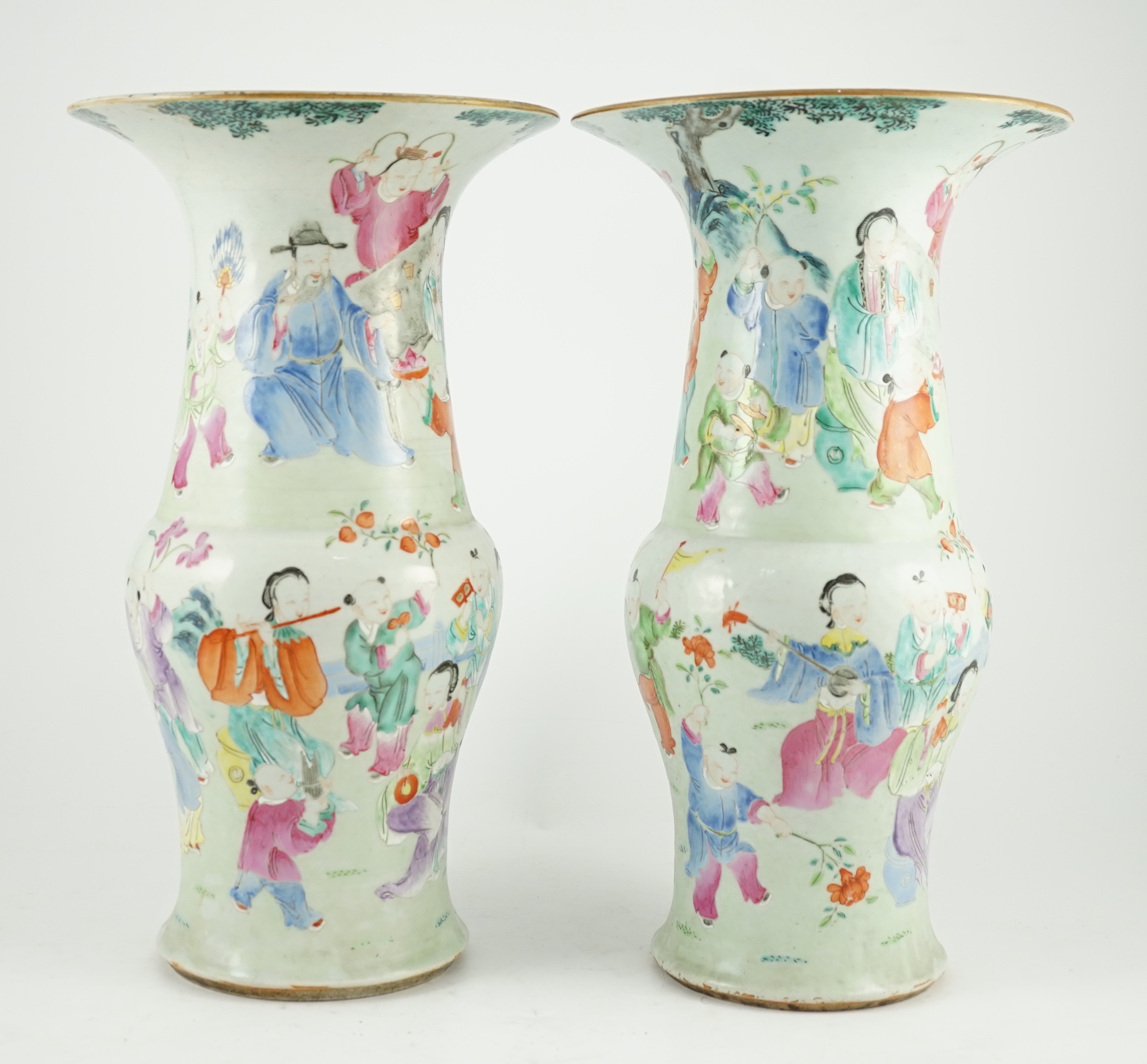 A pair of Chinese famille rose fencai ‘boys’ baluster vases, 19th century, 39.7 and 40cm high, hairline cracks